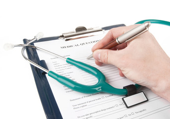 Doctor filling in medical questionnaire form in a clipboard