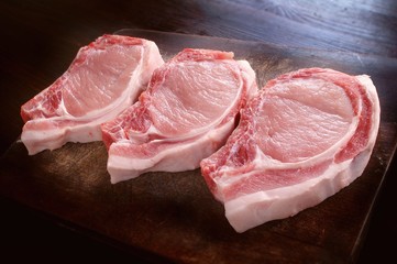 Pork chops on wooden bard