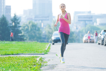 Jogging woman running in city park