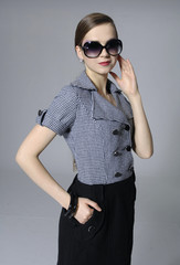Portrait of an attractive young woman in sunglasses posing