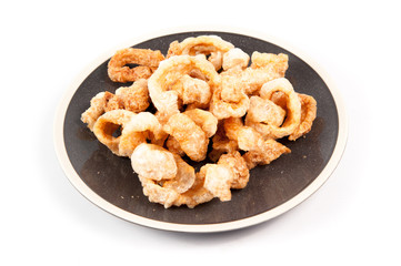 Fried pork rinds over a white background