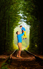 Naklejka premium father and son together in railway green tonel