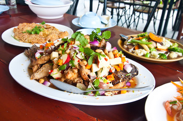 Herb salad with deep fried fish and lemongrass. Thai food.