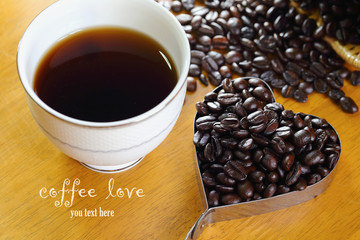 coffee cup and Coffee Beans heart shape  on wooden table