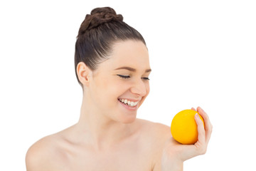 Obraz na płótnie Canvas Happy pretty model holding orange
