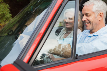 Happy mature man having a ride with his wife