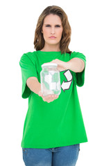 Serious environmental activist holding glass looking at camera