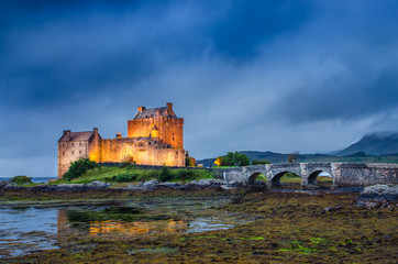 Fototapeta premium View of Eilean Donan castle at sunset in Scottish highlands