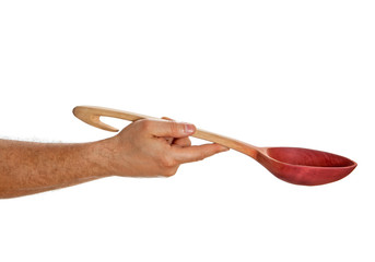 Hand holding wooden spoon