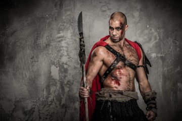 Wounded gladiator in red coat with spear