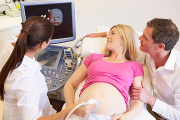 Fototapeta premium Pregnant Woman And Partner Having 4D Ultrasound Scan