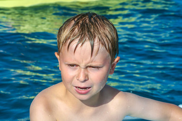 cute boy on a boat is angry