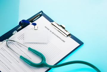 Empty ID tag with medical questionnaire and stethoscope