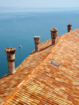 Roof tiles and chimneys on Duino castle, Italy, Eu.
