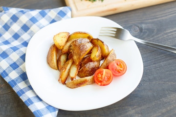 Fried potato wedges with cherry tomato