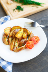 Fried potato wedges with cherry tomato