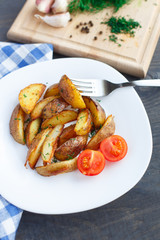 Fried potato wedges with cherry tomato