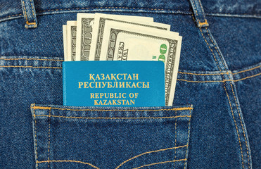 Kazakhstan passport and dollar bills in the back jeans pocket