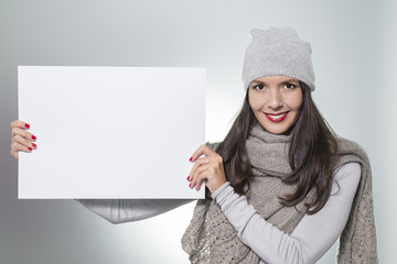 Smiling woman holding a blank sign