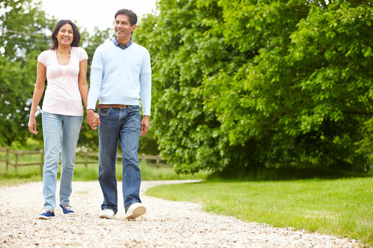 Indian Couple Walking In Countryside