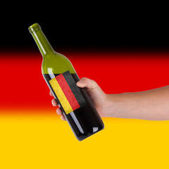 Hand holding a bottle of red wine