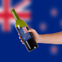 Hand holding a bottle of red wine