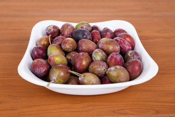 Acid purple and green Plums (Blackthorns)in bowl
