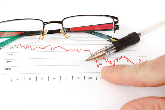 men analyzing business graph with glasses in the background