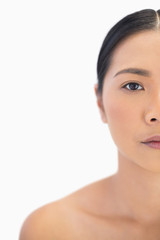 Fototapeta premium Half face of serious natural woman