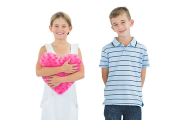 Smiling girl holding heart shaped soft toy