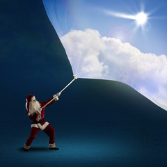 Santa Claus pulls the banner with day sky