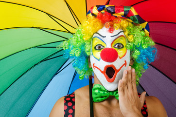 Clown with umbrella isolated on white