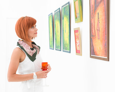 woman admiring paintings in an art gallery