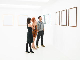 group of people contemplating artworks