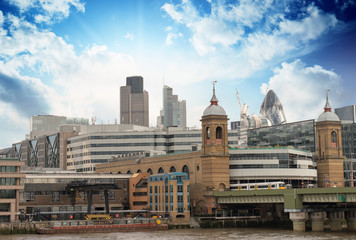 Fototapeta na wymiar City of London with clouds, financial center and Canary Wharf at