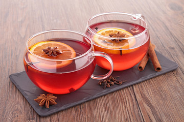 cup of red tea and orange
