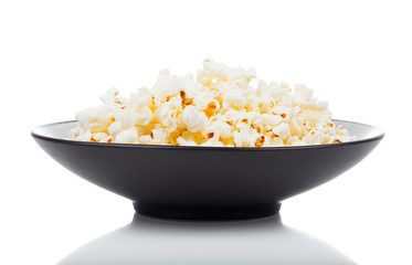 Popcorn in a bowl, isolated on white