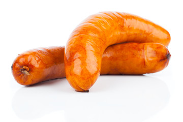 Stack of cooked sausages, on a white background