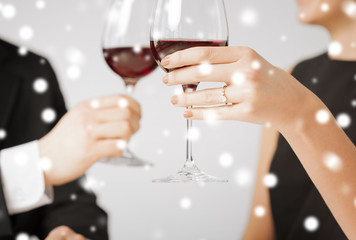 engaged couple with wine glasses