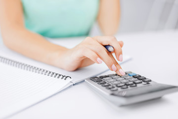 businesswoman working with calculator in office - obrazy, fototapety, plakaty