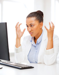 stressed african woman with computer