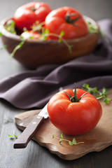 fresh tomatoes on cutting board