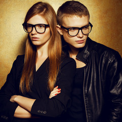Portrait of gorgeous red-haired fashion twins in black clothes