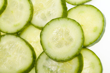 Freshly sliced cucumber  isolated on white background