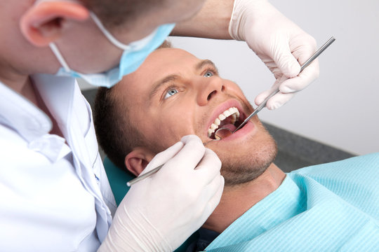 Patient at dentist office. Top view of man sitting at the chair