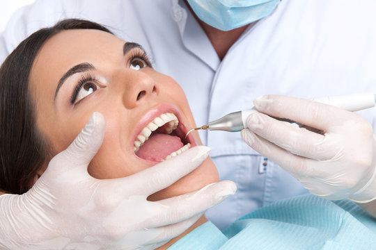Patient at dentist office. Close-up of beautiful young woman sit