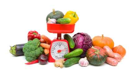 kitchen scale and vegetables isolated on a white background