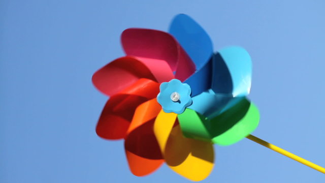 One colorful pinwheel over blue sky background, 1080