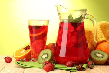 sangria in jar and glass with fruits,