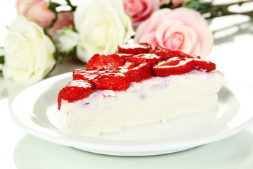 Cheesecake with fresh strawberry on white plate closeup
